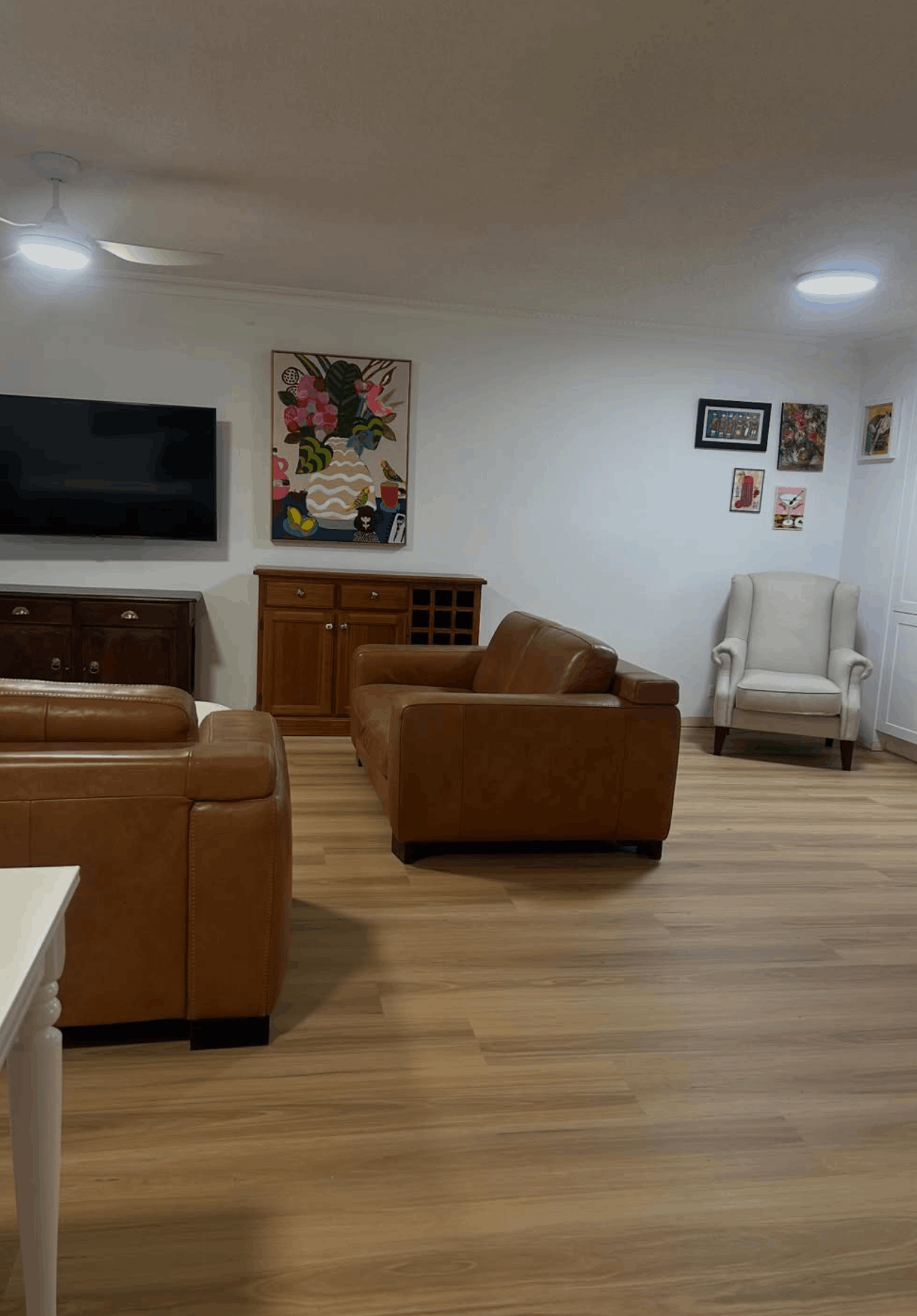Warm timber-look flooring laid through a family living room on the Gold Coast
