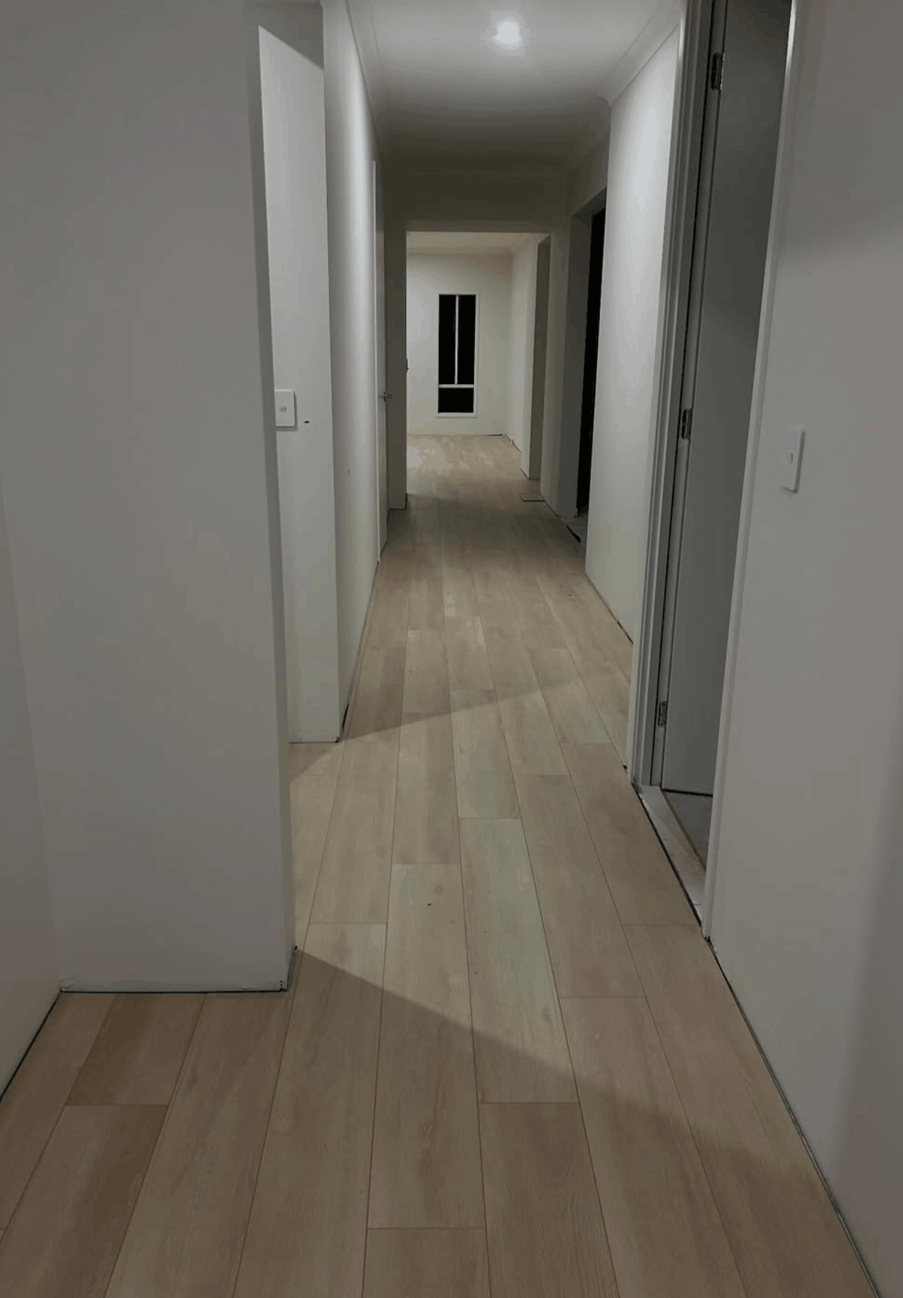 Pale hybrid flooring installed through a long hallway in a renovated Queensland home
