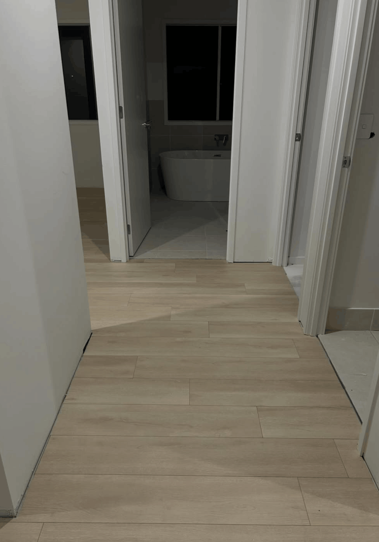 Light oak hybrid flooring through hallway and ensuite in a new Brisbane home