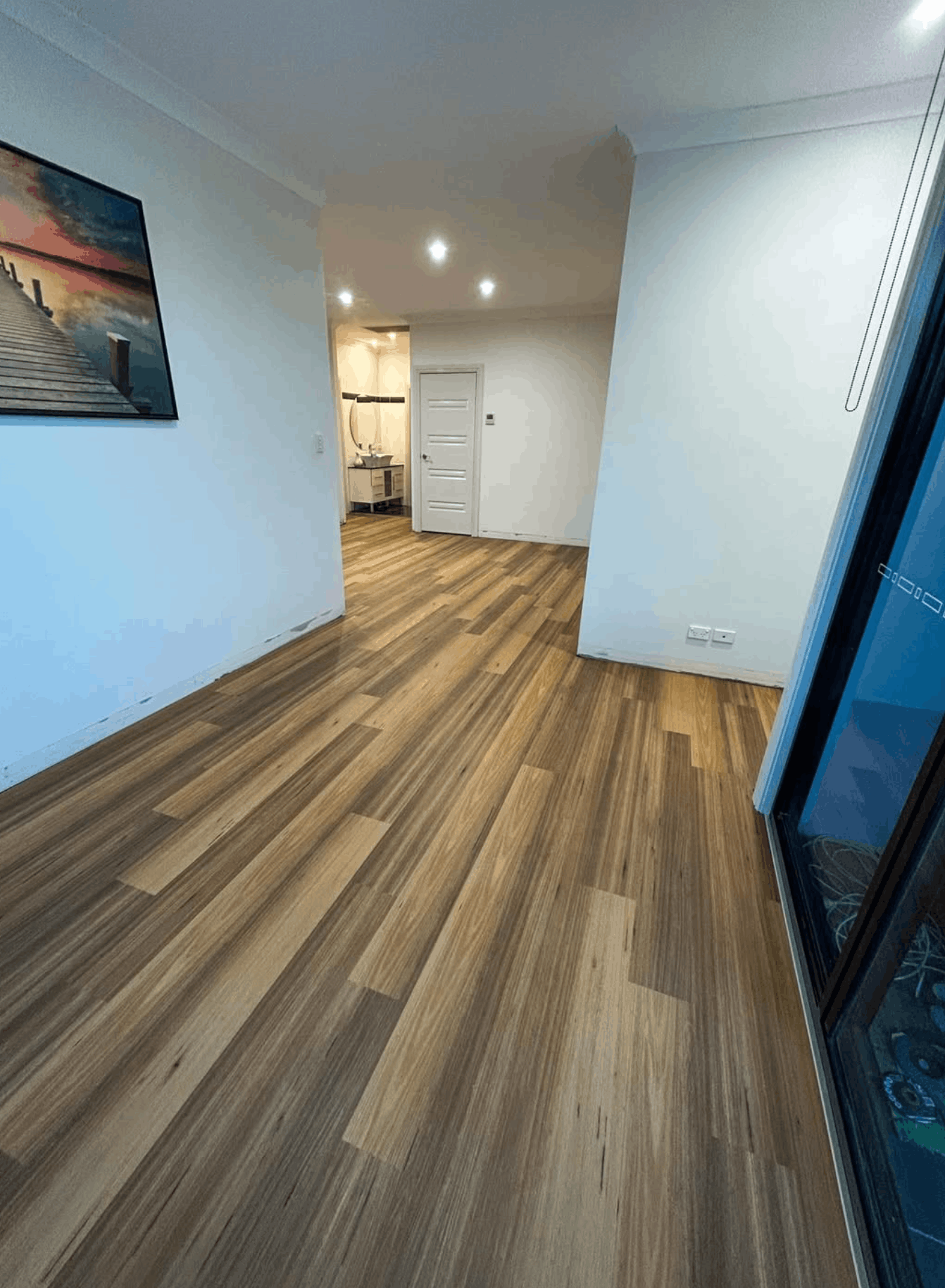 Spotted gum laminate flooring laid through a Brisbane living and dining area